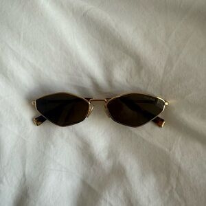 MIU MIU Narrow Oval Sunglasses in Gold